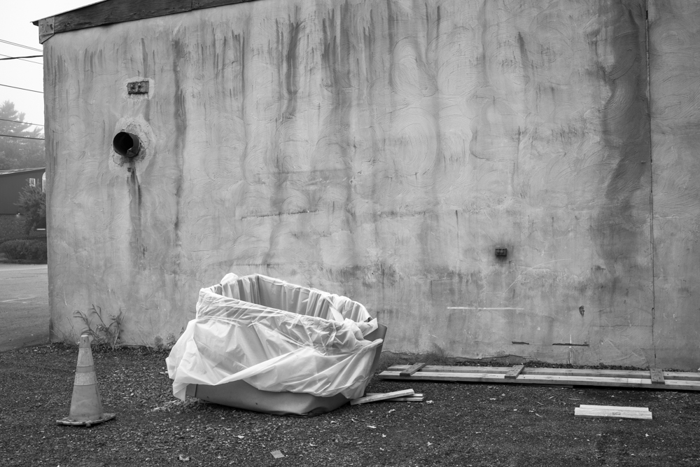 Box with Plastic Wrap Against Wall
